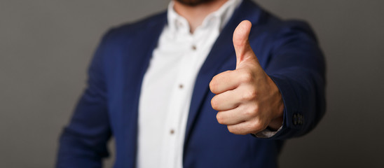 Unrecognizable businessman showing thumb up gesture panorama