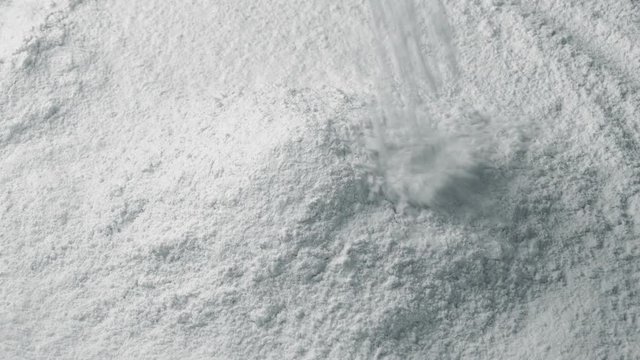White Powder Pours Into Pile