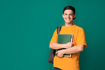 Happy student with books and backpack over background - obrazy, fototapety, plakaty