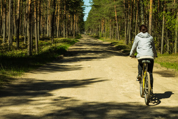 Young women cycling in the forest