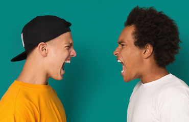 Two angry teens shouting at each other