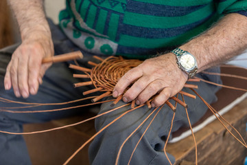  A basket weaver at work in the factory shop in Camacha on Madeira Island,  Portugal