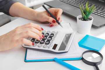 Business woman working with financial data hand using calculator - obrazy, fototapety, plakaty