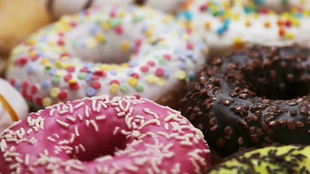 assorted donuts with different fillings and icing. Rotation video