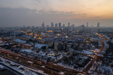 Naklejka na ściany i meble widok na Warszawa zachód słońca z drona pierwszy śnieg
