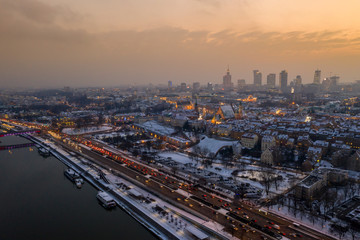 Naklejka na ściany i meble widok na Warszawa zachód słońca z drona pierwszy śnieg