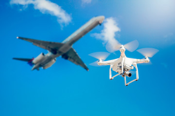 drone fly close to the commercial airplane near the airport - obrazy, fototapety, plakaty
