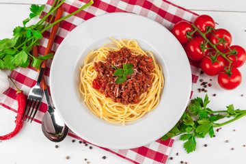 Pasta with meat, tomato sauce and vegetables on the table