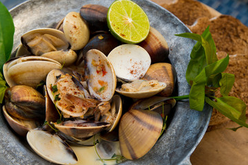 Spaghetti Crap meat with Baked Scallop Mussel on white plate, Fusion food stylish arrange on glass table along ocean mangrove tree Island, empty copy space for text logo