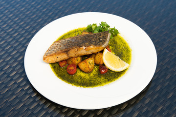 Deep Fried Salmon Seabass fish cut meat with fried potato chip, Fusion food stylish arrange on glass table along ocean mangrove tree Island, empty copy space for text logo Yummy