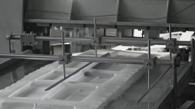 Plastic lunch boxes manufacture plant, disposable food package ware production line. Work on high performance automated machinery. Container for lunch sets for supermarket, railway or airline company