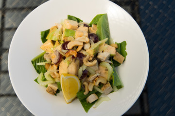 Ceacar vegetable Salad recipe homemade dressing, Fusion food stylish arrange on glass table along ocean mangrove tree Island, empty copy space for text logo Yummy