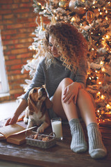 Fototapeta na wymiar Woman with a dog for Christmas 