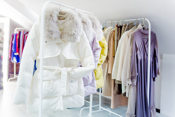 Fashion winter coats hanged on a clothes rack