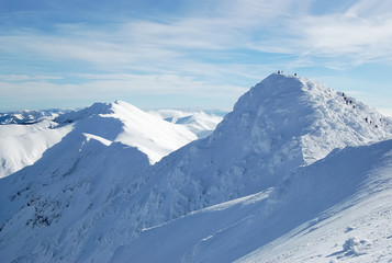 View of the peak of the snow-covered Chopok mountain and the Low Tatras mountain range in the ski resort Jasna, Slovakia.