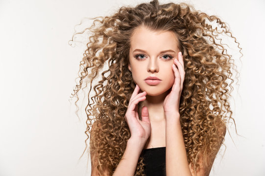 Young girl brushing her hair, unruly hair tangled. Bad hair day. Hair care.