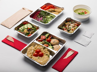 Take away meals in aluminium boxes with cutlery