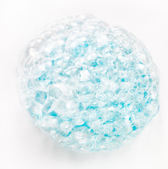 Soap bubbles on a white background from blue shower gel, top view.