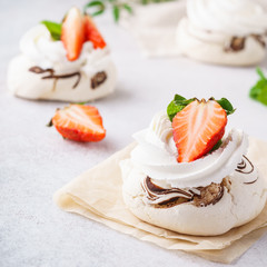 Pavlova cakes with cream and fresh summer berries