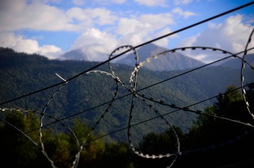 barbed wire on background of blue sky