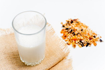 a glass of milk with bread and grains