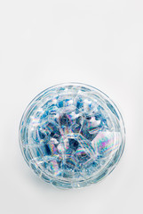 A circle of soap bubbles from blue shower gel on a white background.