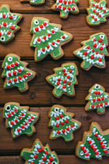Homemade colorful gingerbread cookies on dark wooden background.