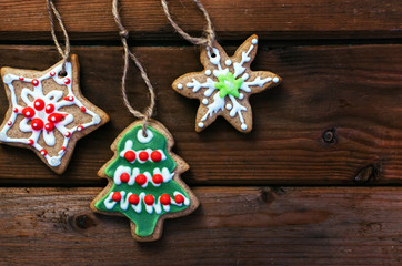 Homemade colorful gingerbread cookies on dark wooden background.