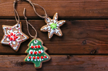 Homemade colorful gingerbread cookies on dark wooden background.