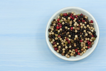 Bowl with different pepper grains.
