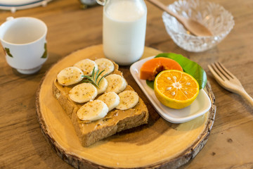 breakfast with banana peanut butter toast and fruits milk
