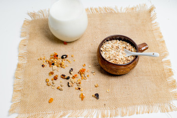 different types of groats in pots on a white background