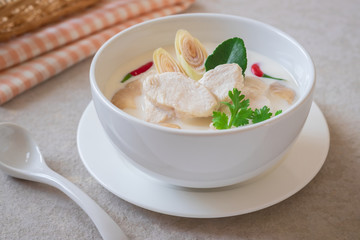 Chicken with coconut milk soup in white bowl, Thai food (Tom Kha Kai).