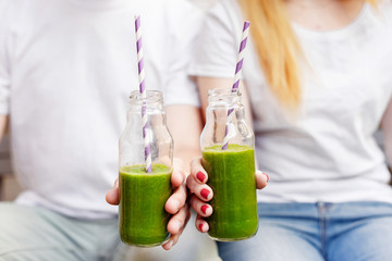 Young couple drinking green smoothie. Healthy life style concept. - Powered by Adobe