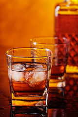 Glass of scotch whiskey with natural ice .
