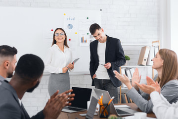 Business team congratulating successful managers with applause