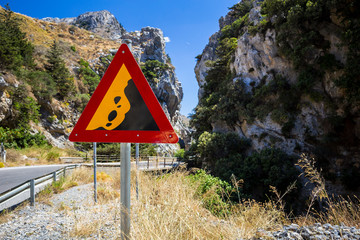 Falling stone warning traffic sign in a mountains