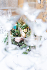  composition of the Christmas tree through the glasses in the restaurant,  top view, gold toys