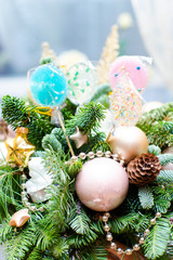 Fototapeta na wymiar many colorful lollipop on decorated Christmas tree, top view,balls, stars, cones, hearts, gold toys