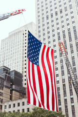 close up view of american flag and buildings in new york city, usa