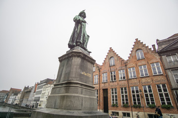 Fototapeta na wymiar Jan Van Eyck memorial and Typical belgian architecture in Bruges - old town - Belgium