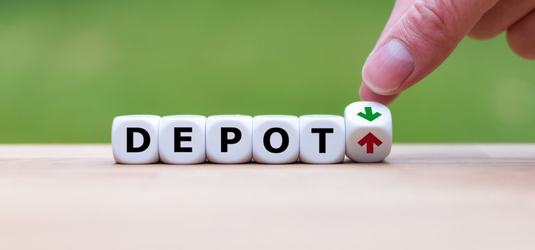 Hand is turning a dice and changes the direction of an arrow symbolizing that the value of a depot is going up (or vice versa)