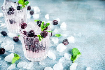 Homemade blackberry lemonade on light blue concrete background copy space
