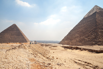 Fototapeta na wymiar Pyramids of Giza - Chephren and Cheops back side and background view on Cairo, the capital of Egypt