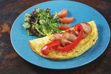 Delicious breakfast. Fried omlette with sliced ham