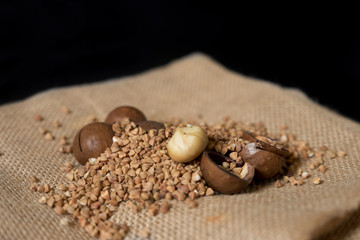 Macadamia nut on burlap with buckwheat.