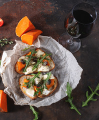bruschetta with pumpkin, cheese and arugula