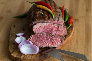 Food. Steak filet mignon, decorated chili and onions