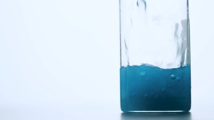 Flask with blue liquid inside. Slow motion footage. - Powered by Adobe