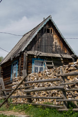  House in the village, firewood, fence, summer.